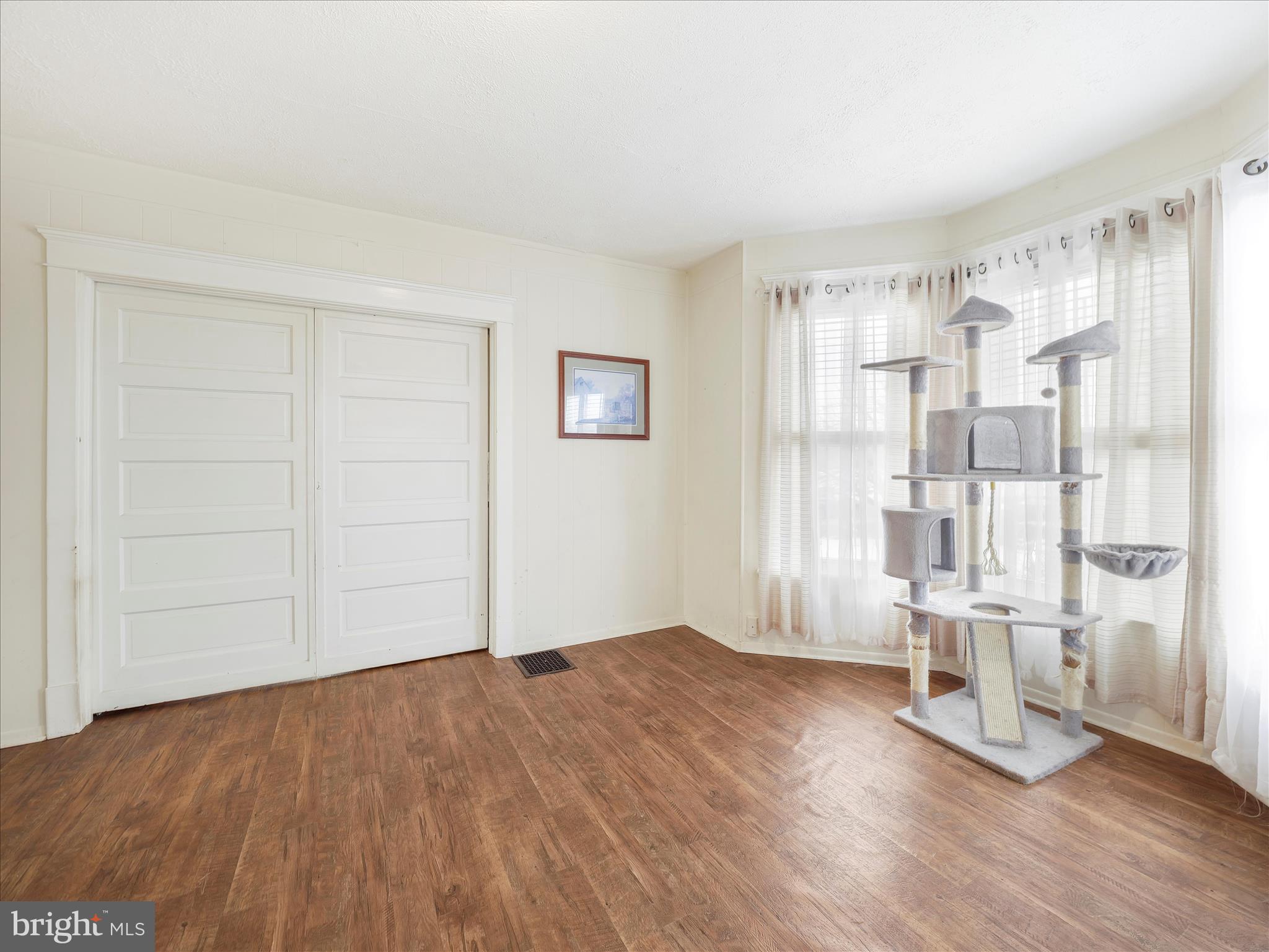 5825 Front Street Chambersburg, PA 17202 - Photo 15 of 37 an empty room with wooden floor and windows