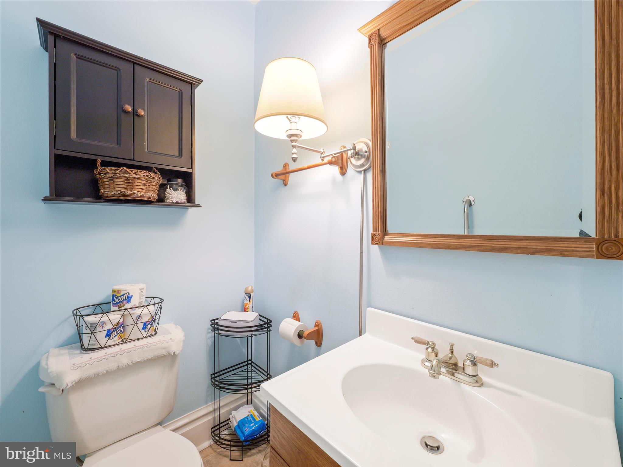 5825 Front Street Chambersburg, PA 17202 - Photo 19 of 37 a bathroom with a sink a toilet and a mirror