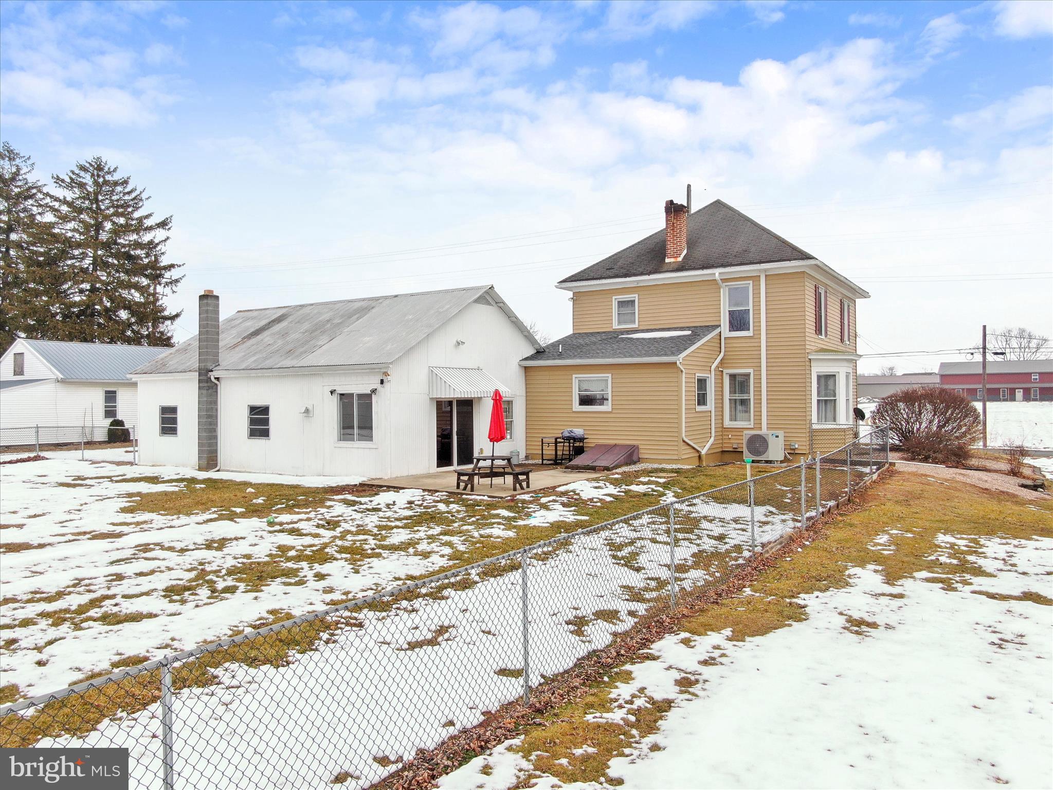 5825 Front Street Chambersburg, PA 17202 - Photo 33 of 37 a view of a large white house next to a yard
