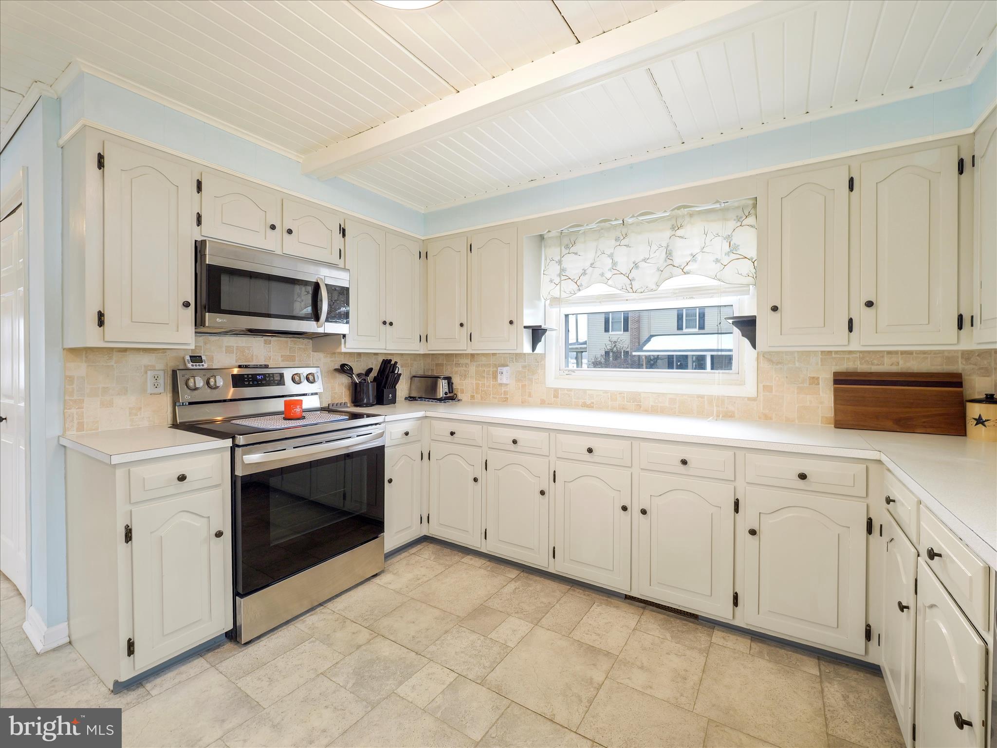 5825 Front Street Chambersburg, PA 17202 - Photo 7 of 37 a kitchen with granite countertop white cabinets sink and stainless steel appliances