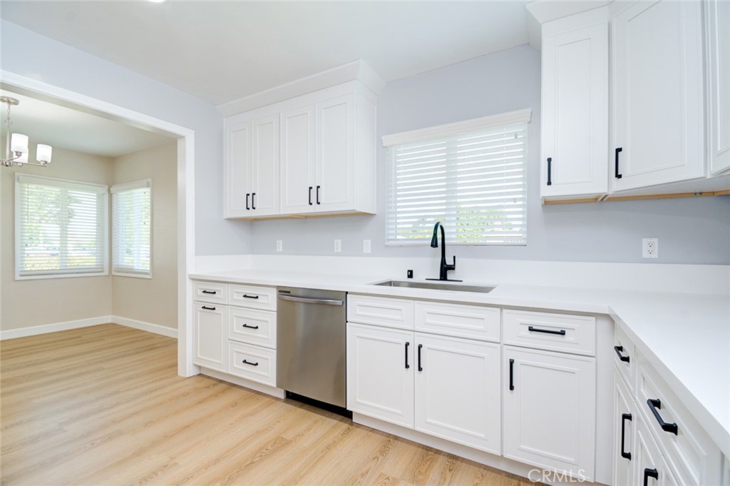 306 West Porter Avenue Fullerton, CA 92832 - Photo 6 of 74 a kitchen with white cabinets and a sink