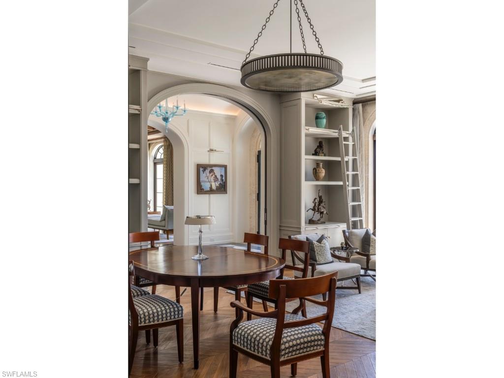 4296 Cutlass Lane Naples, FL 34102 - Photo 11 of 35 a dining room with a table and chairs