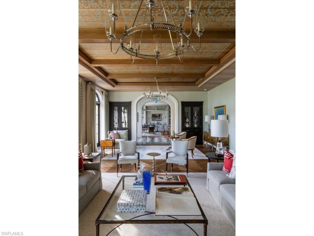 4296 Cutlass Lane Naples, FL 34102 - Photo 15 of 35 a living room with furniture and a chandelier