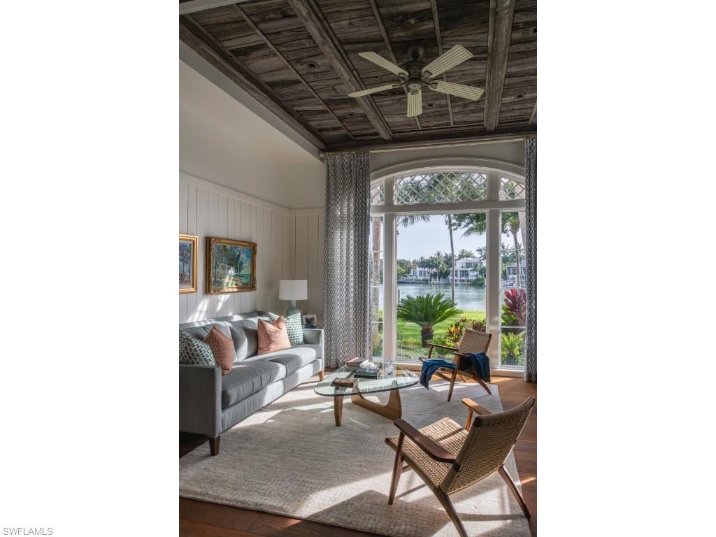 4296 Cutlass Lane Naples, FL 34102 - Photo 17 of 35 a living room with furniture and a potted plant
