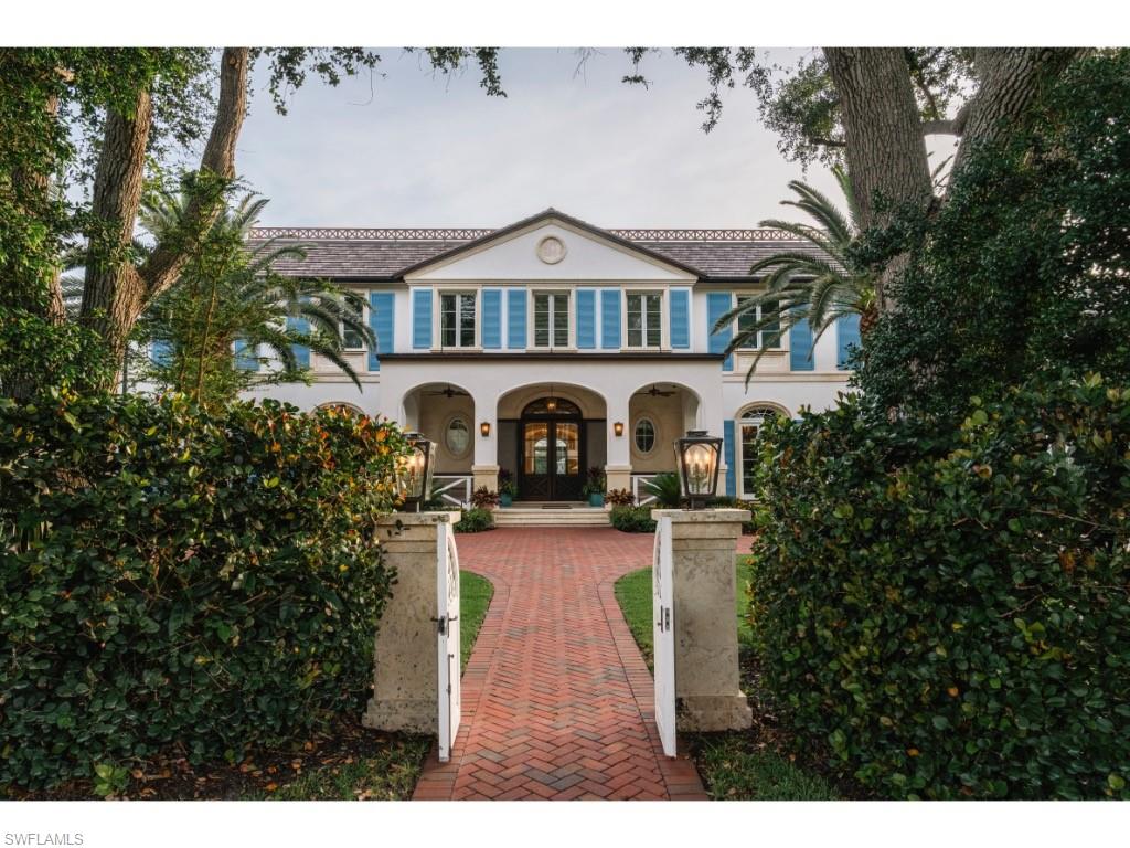 4296 Cutlass Lane Naples, FL 34102 - Photo 2 of 35 a front view of a house with garden