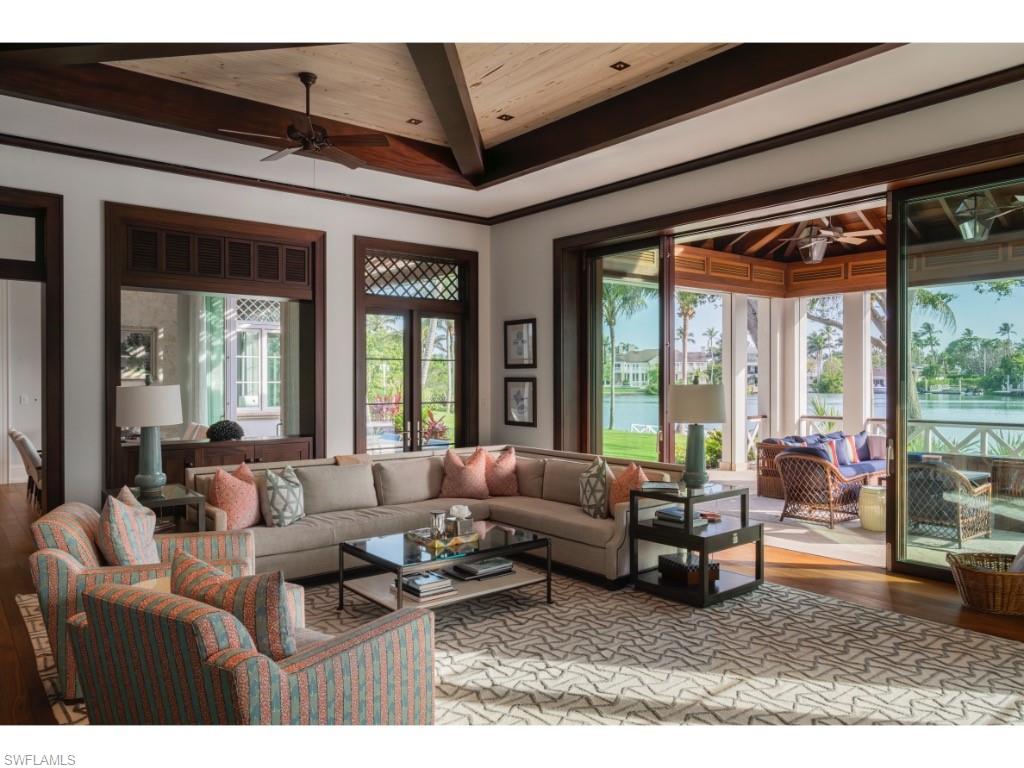 4296 Cutlass Lane Naples, FL 34102 - Photo 21 of 35 a living room with furniture and large windows