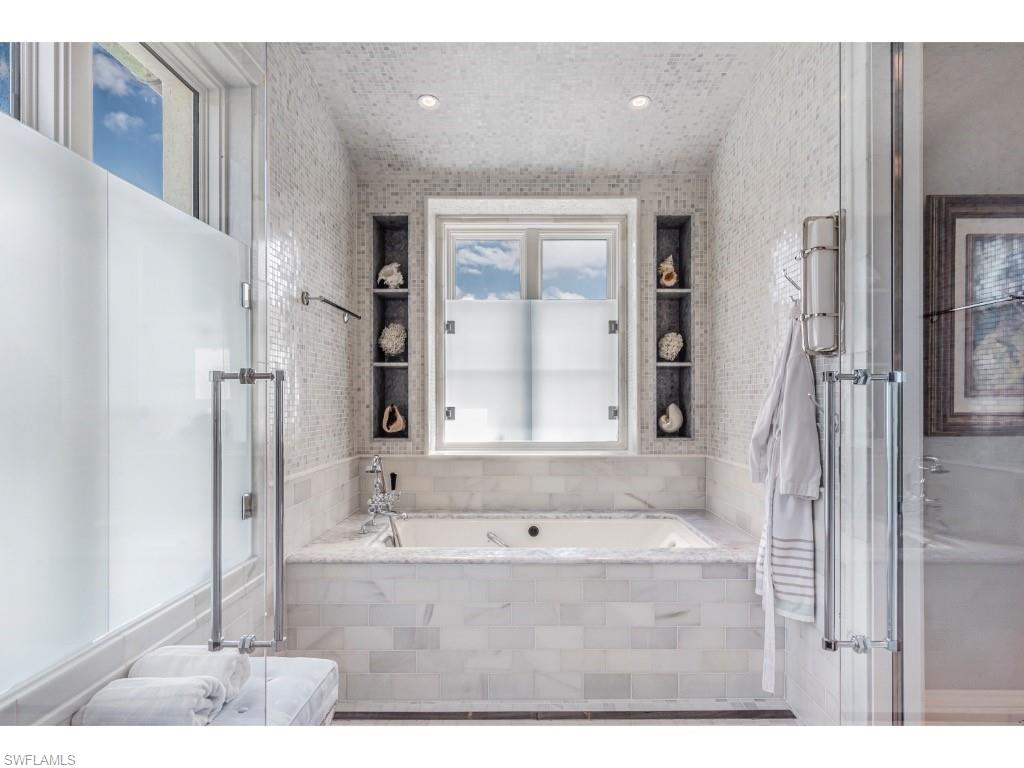 4296 Cutlass Lane Naples, FL 34102 - Photo 22 of 35 a bathroom with a tub shower and sink