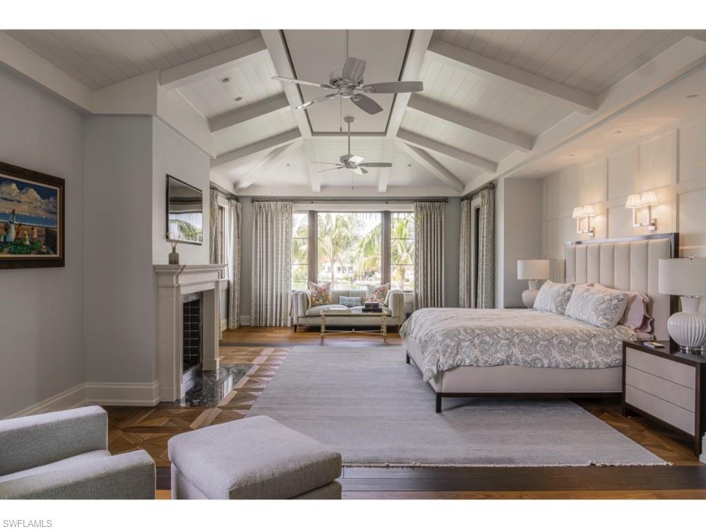 4296 Cutlass Lane Naples, FL 34102 - Photo 24 of 35 a living room with furniture and large windows