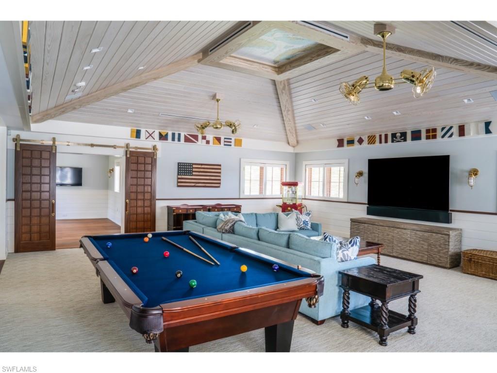 4296 Cutlass Lane Naples, FL 34102 - Photo 25 of 35 a living room with furniture pool table and a flat screen tv