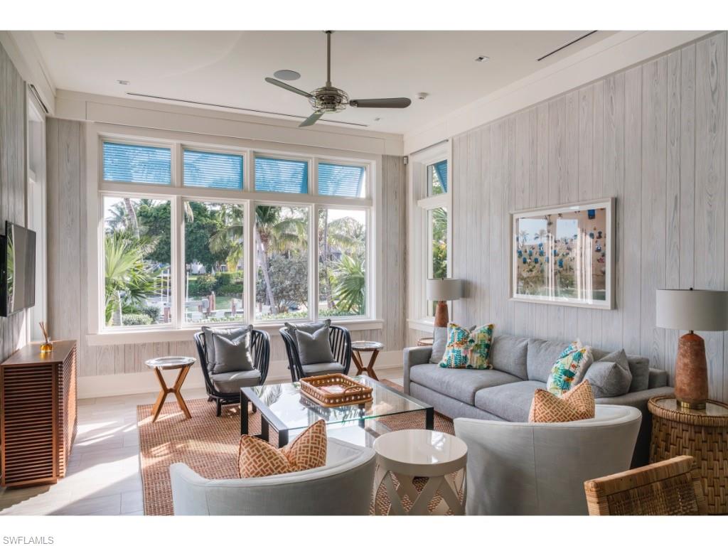 4296 Cutlass Lane Naples, FL 34102 - Photo 28 of 35 a living room with furniture and a large window