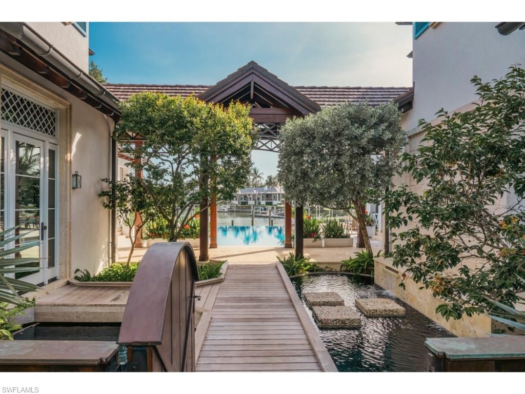 4296 Cutlass Lane Naples, FL 34102 - Photo 30 of 35 a view of a house with a yard