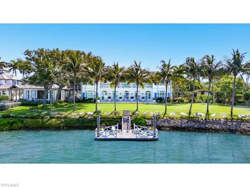 4296 Cutlass Lane Naples, FL 34102 - Photo 35 of 35 a view of a swimming pool and a garden