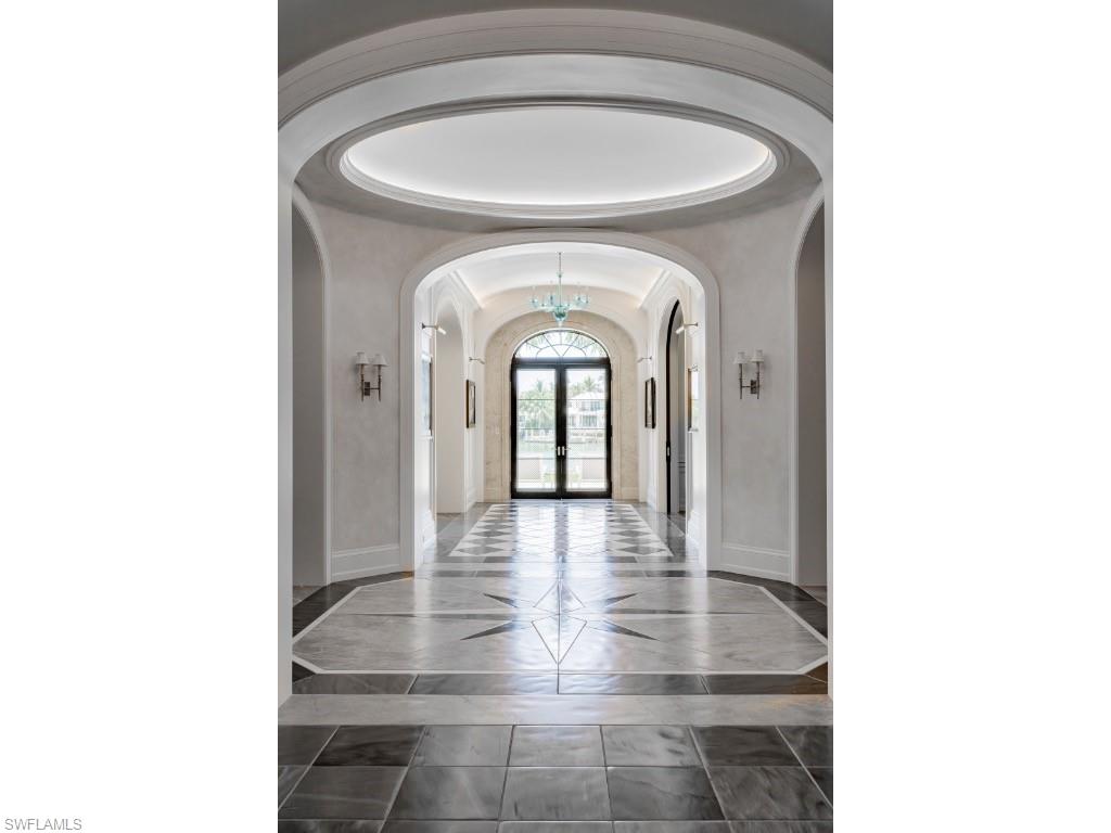 4296 Cutlass Lane Naples, FL 34102 - Photo 8 of 35 a view of a livingroom with wooden floor and a large window