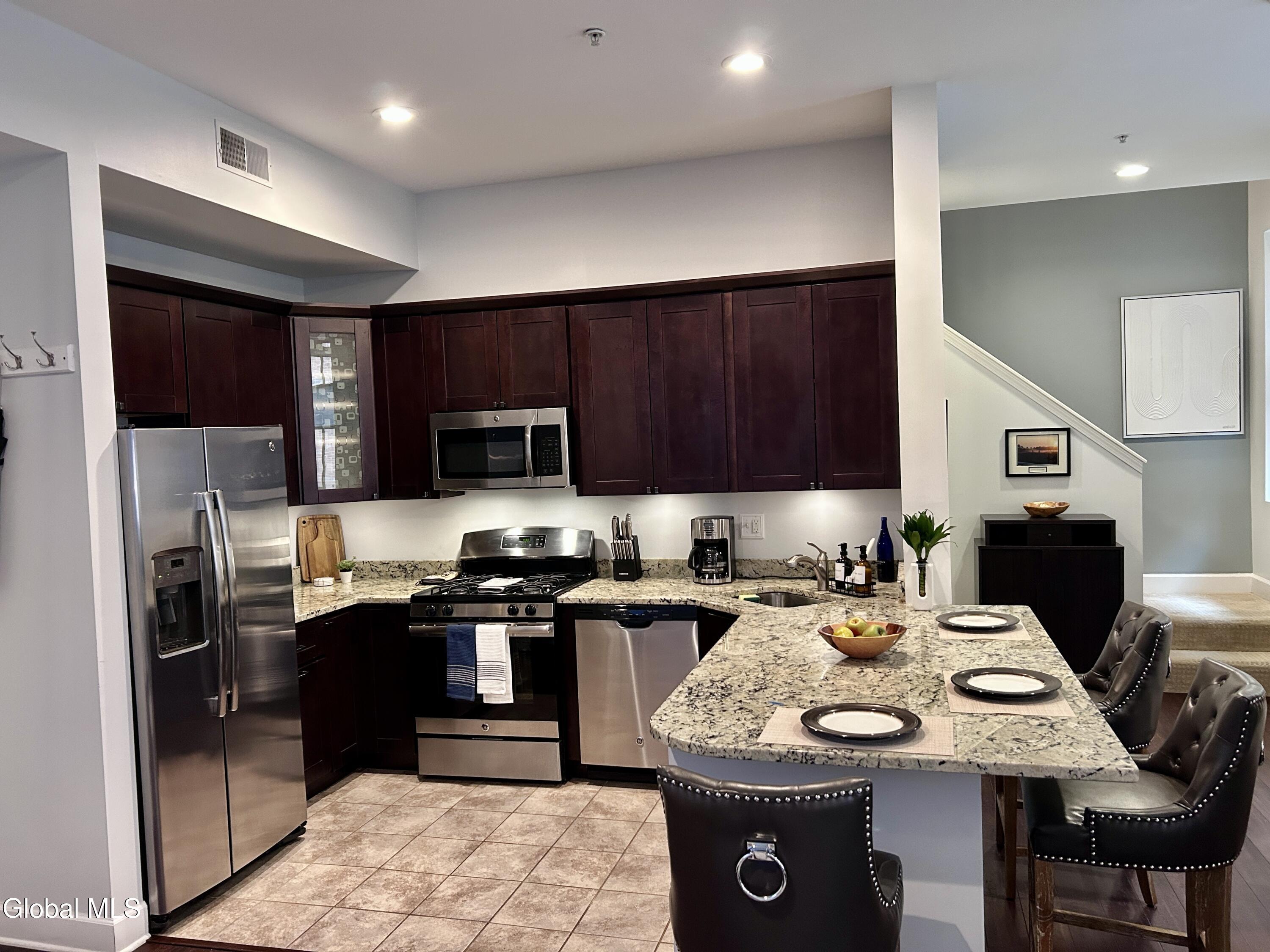 5 Spring Street, Unit 101 Saratoga Springs, NY 12866 - Photo 5 of 25 Kitchen/Granite/Island