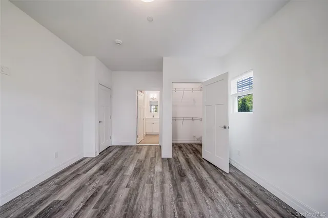 a view of a room with wooden floor and a ceiling fan