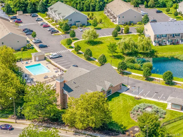 an aerial view of residential houses with outdoor space and swimming pool