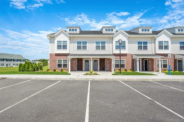 a front view of a building with a yard