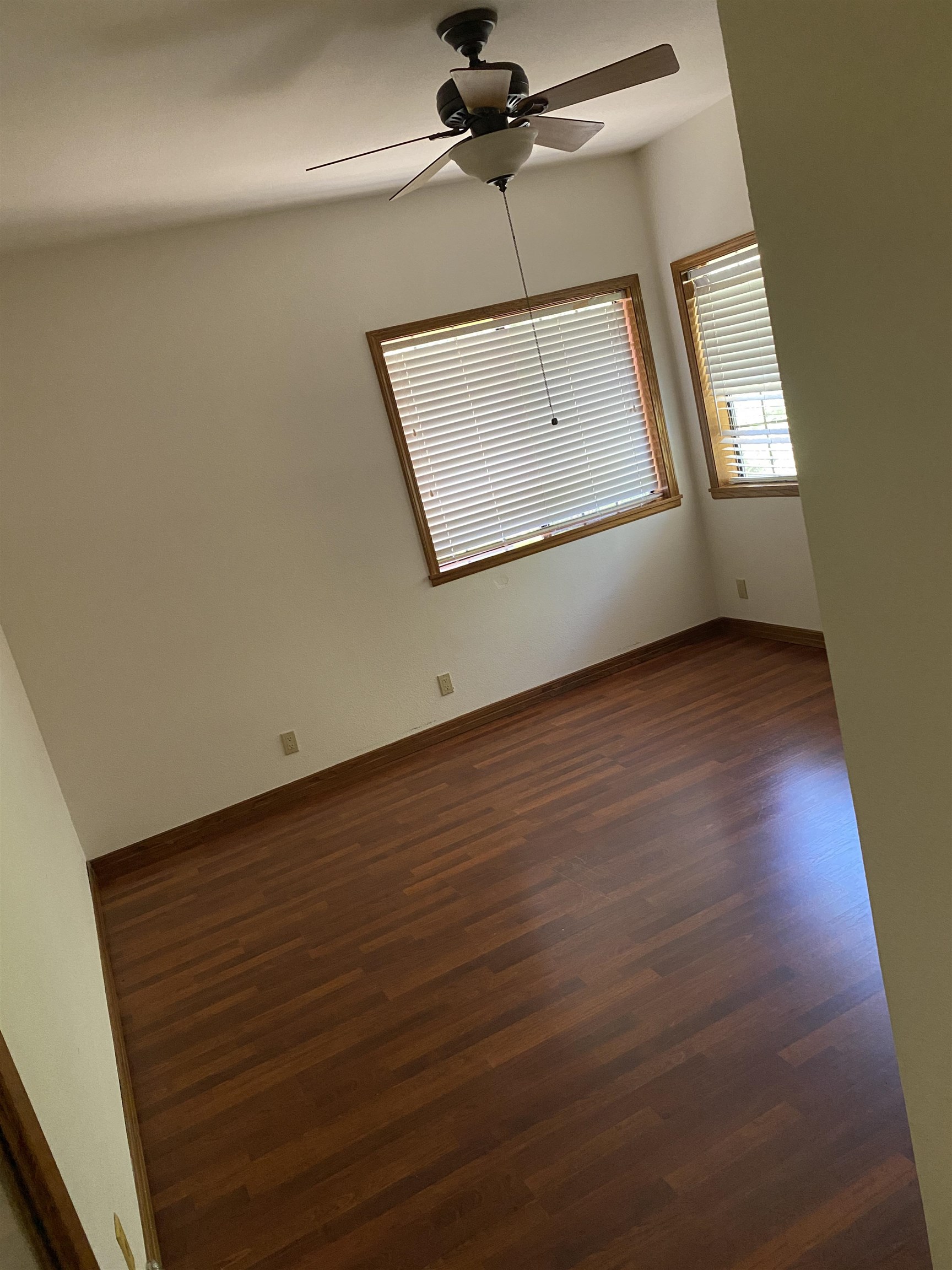 11 Foothill Lane Pleasanton, CA 94588 - Photo 12 of 38 an empty room with wooden floor ceiling fan and windows