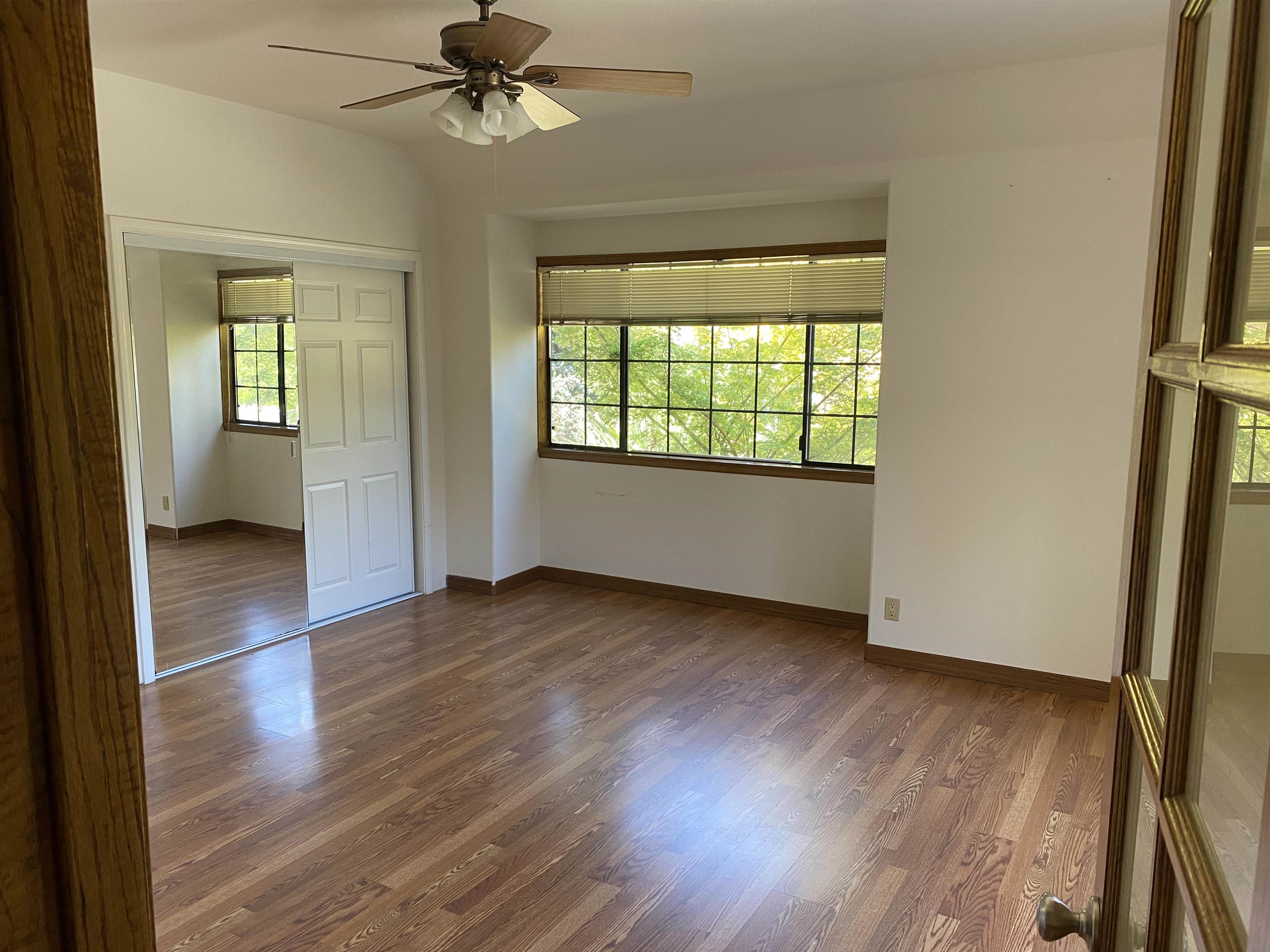 11 Foothill Lane Pleasanton, CA 94588 - Photo 22 of 38 an empty room with wooden floor fan and windows