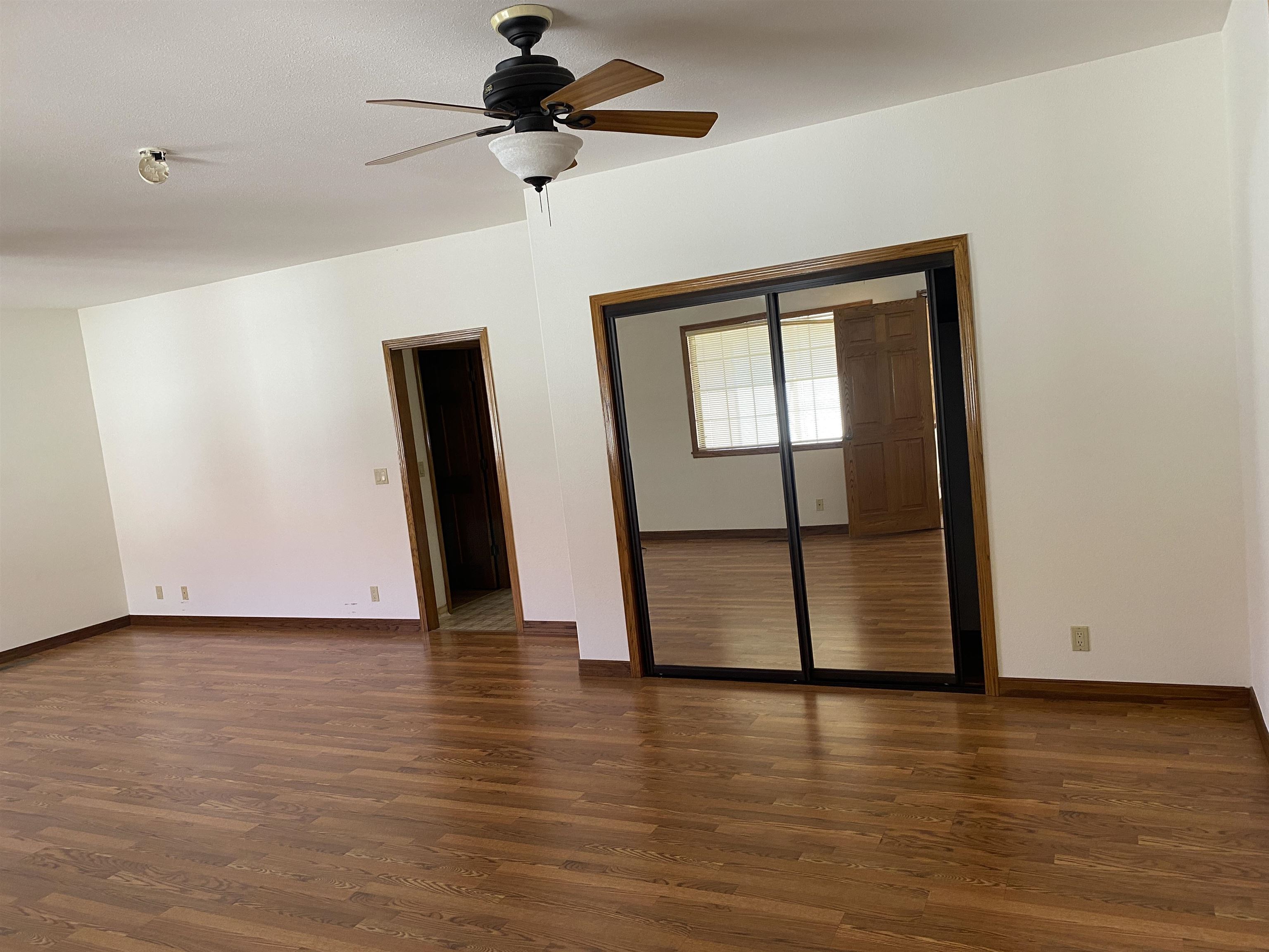 11 Foothill Lane Pleasanton, CA 94588 - Photo 5 of 38 a view of an empty room with wooden floor and a ceiling fan