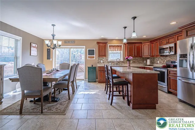 a dining table with chairs and kitchen view