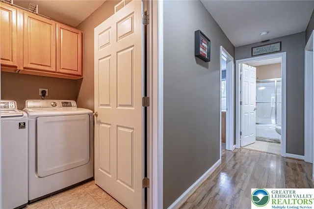 a view of washer and dryer with wooden floor