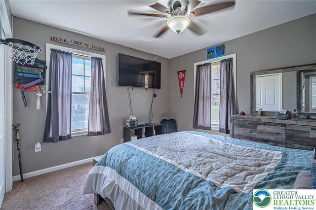 a bedroom with a large bed and a chandelier