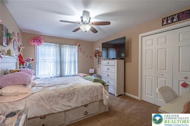 a bedroom with a bed and ceiling fan