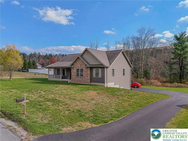 a view of a house with a yard and potted plants