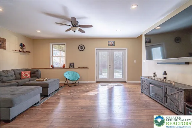 a living room with furniture and a wooden floor