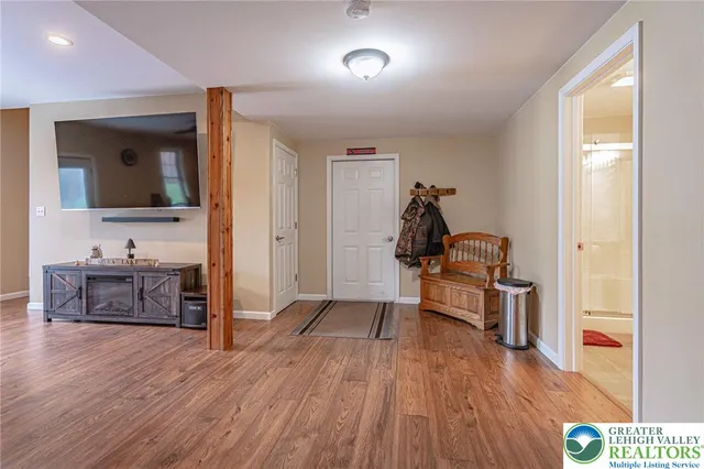 a view of a workspace with furniture and wooden floor