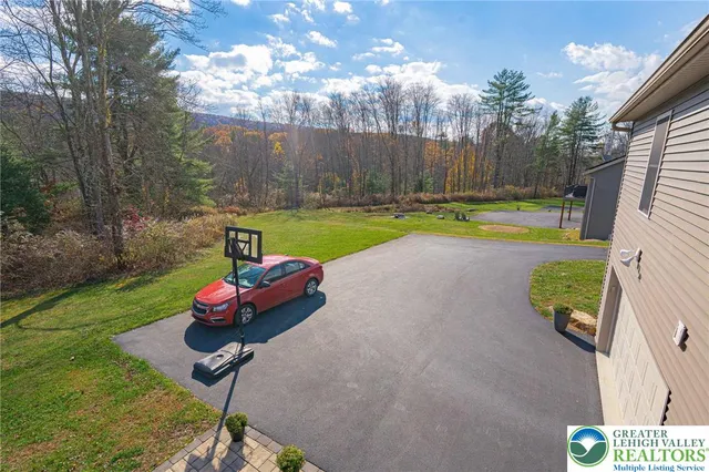a view of a backyard with swimming pool