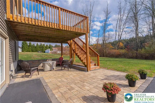 a view of a patio filled with furniture and yard