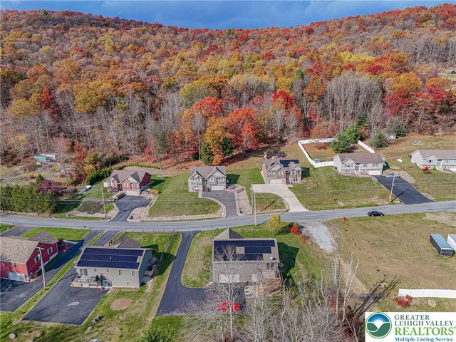 an aerial view of residential houses with outdoor space