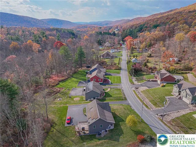an aerial view of residential houses with outdoor space