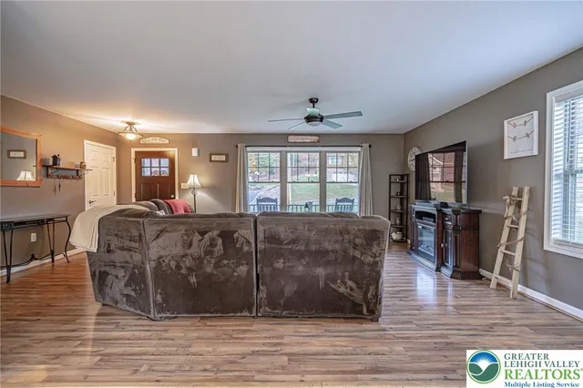 a living room with furniture a flat screen tv and a table