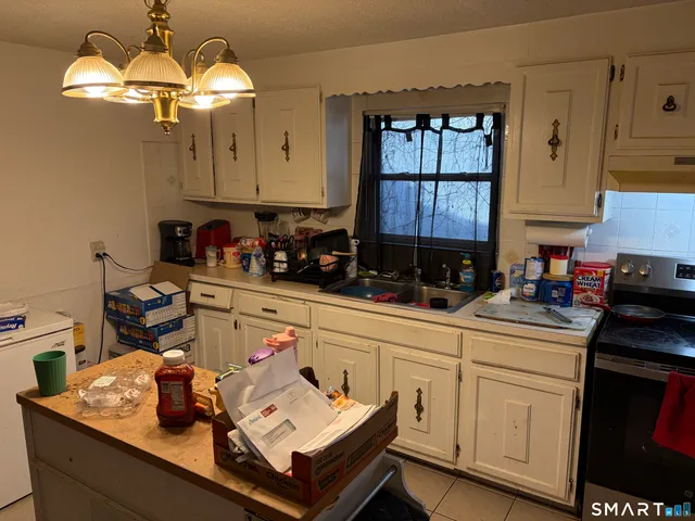 a kitchen with a sink cabinets and window
