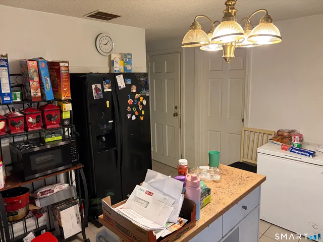 a view of a kitchen with a dining table and chairs