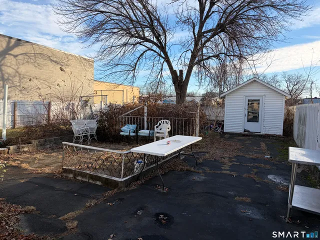 a view of a patio with a table chairs and a fire pit