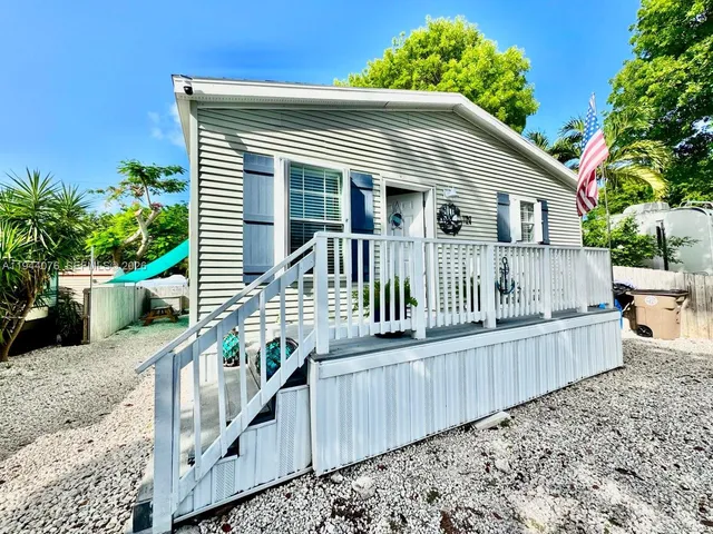 a view of a house with wooden fence