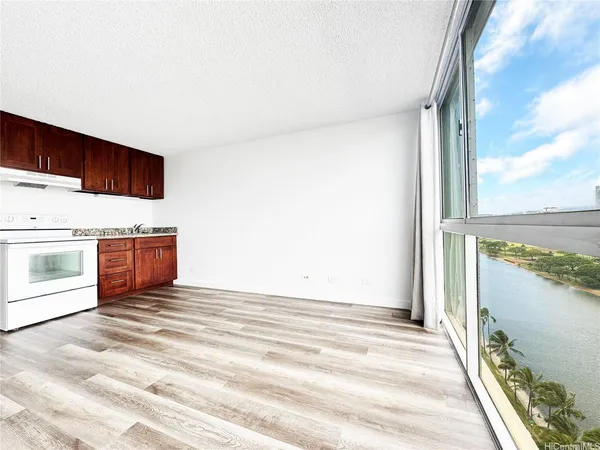 a view of a room with wooden floor and windows