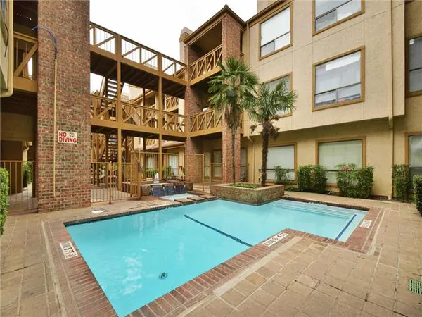 a view of a building with a backyard porch and sitting area