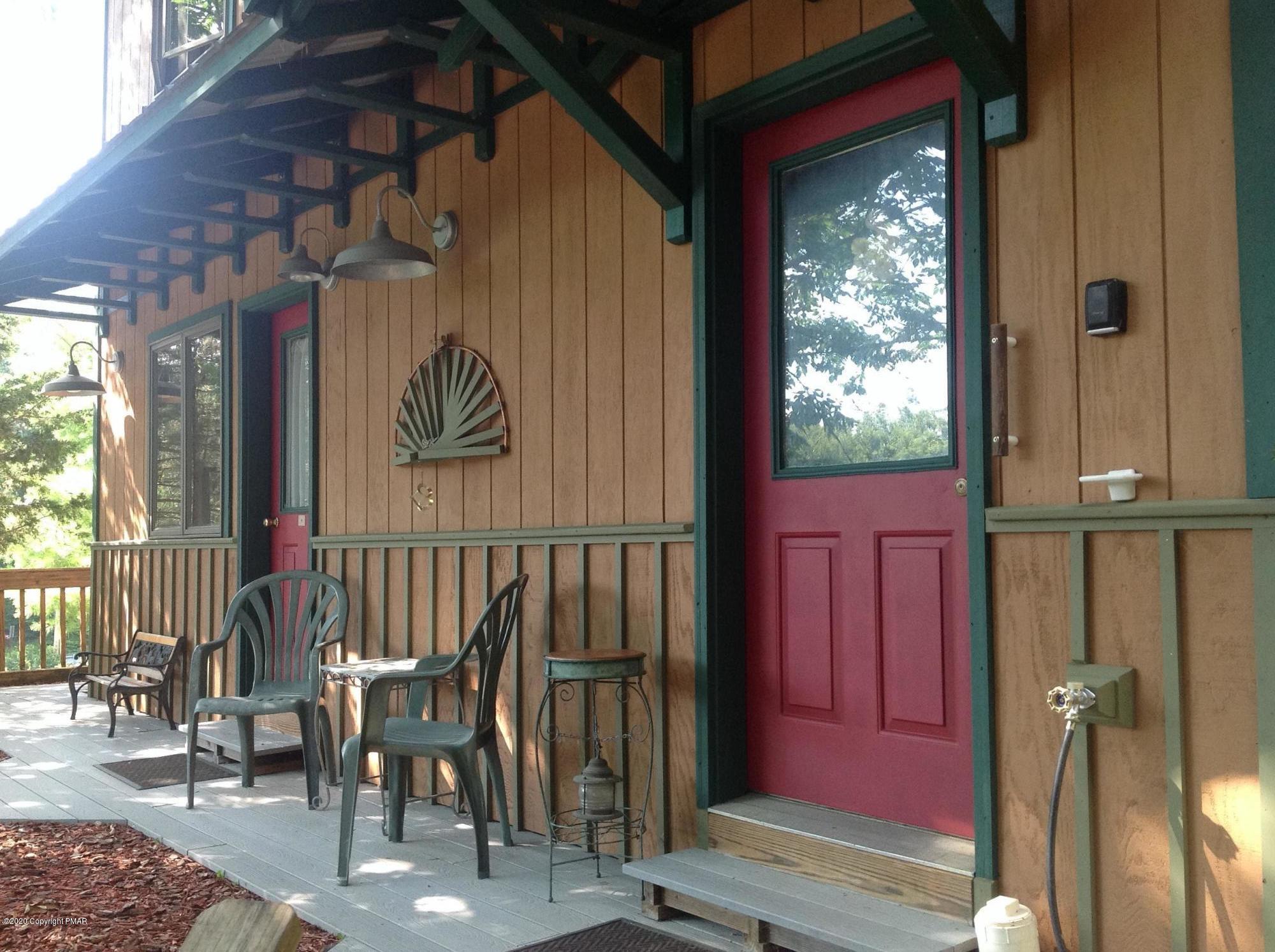 a view of a porch with a table and chairs