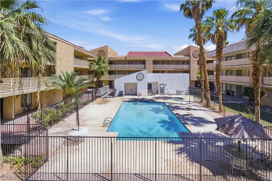 2221 West Bonanza Road, Unit 28 Las Vegas, NV 89106 - Photo 15 of 15 This outdoor oasis features a refreshing pool, surrounded by lush palm trees and inviting lounge areas.