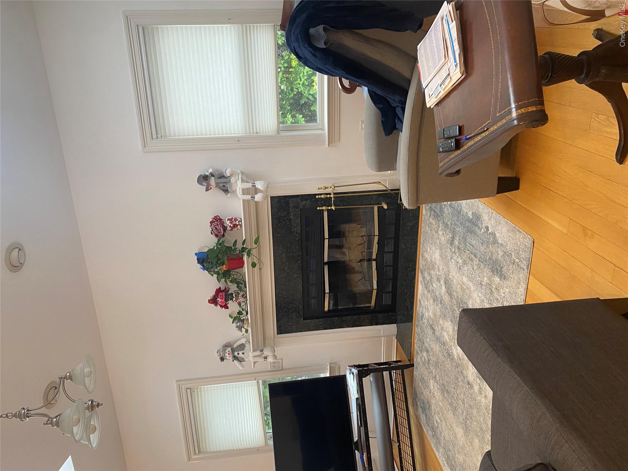 18 Crosshill Road Eastchester, NY 10709 - Photo 5 of 10 a living room with furniture a flat screen tv and a fireplace