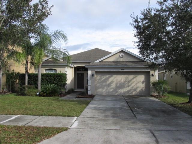 4757 Walnut Ridge Drive Orlando, FL 32829 - Photo 1 of 1 a front view of a house with a yard and potted plants