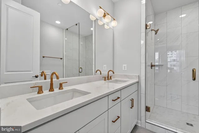 a bathroom with a sink double vanity and shower