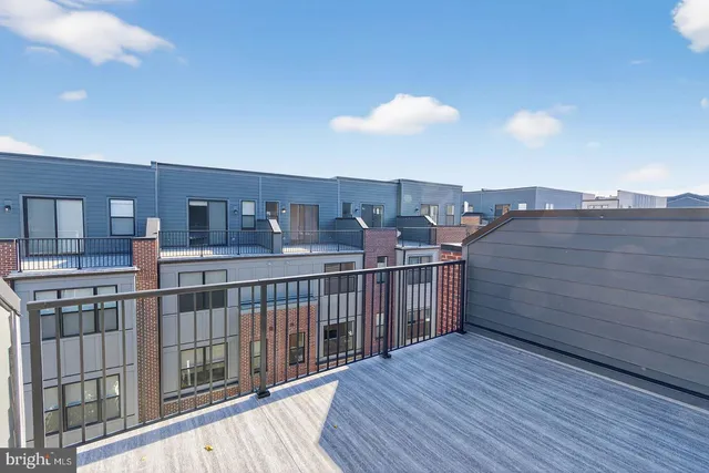 a view of a balcony with wooden floor and city view