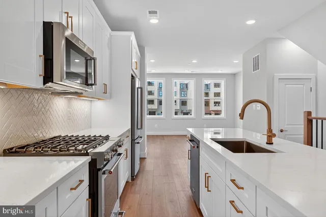 a kitchen that has a sink and a stove