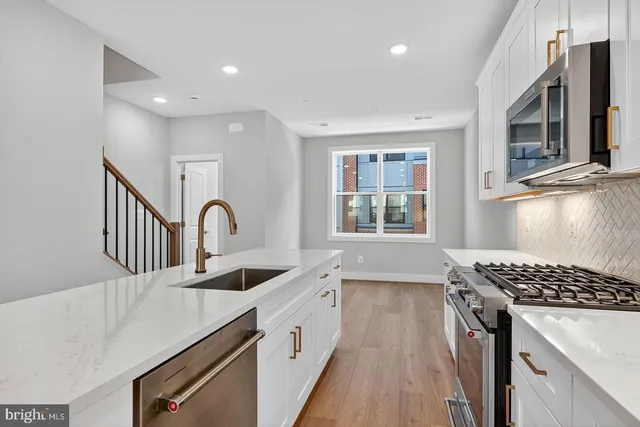 a kitchen that has a sink and a stove